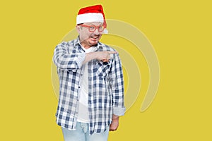 Positive middle aged man in red cap, eyeglasses and checkered sh