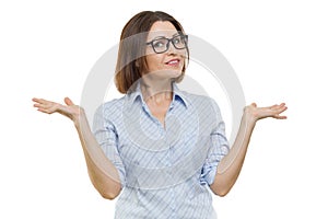 Positive middle-aged woman posing with hands on white background, isolated.