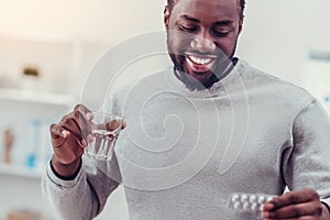 Positive minded African American man taking medication