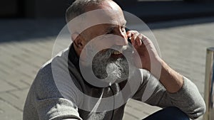 Positive minded bearded guy calling somebody in street