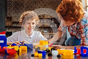 Positive minded brothers playing with lego together