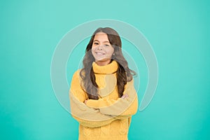 Positive mood. Kids psychology. Adorable smiling girl wear yellow sweater turquoise background. Positivity concept. Good