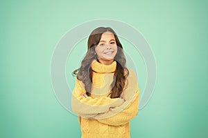 Positive mood. Kids psychology. Adorable smiling girl wear yellow sweater turquoise background. Positivity concept. Good