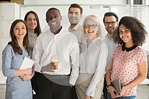 Positive multi racial corporate team posing looking at camera photo