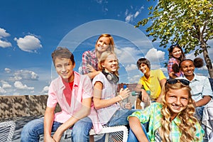 Positive multinational group of kids sit together
