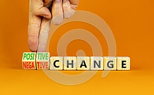 Positive or negative change symbol. Concept word Positive change Negative change on wooden cubes. Beautiful orange background.