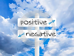 Positive negative text white table and blue sky photo
