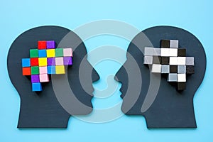 Positive and negative thinking concept. Heads and brain from colored cubes.