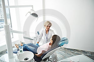 Positive nice dentist having a regular check up