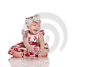 Positive overjoyed baby girl in festive dress shot