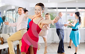 Positive pairs practicing vigorous jive movements in dance class