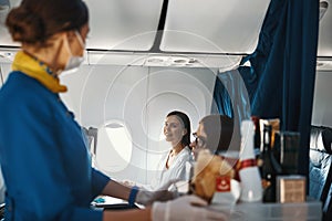 Positive passenger and cabin hostess exchanging looks