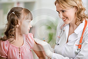Positive pediatrician doctor vaccinating or