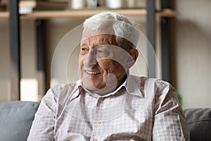 Positive pensive older 80s man looking away with good thoughts