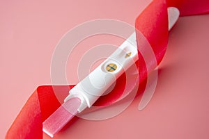 Positive platic pregnancy test isolated on pink background