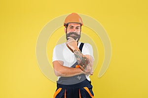 Positive plumber. brutal male worker with beard. he is just artisan. choose your occupation. construction engineer in