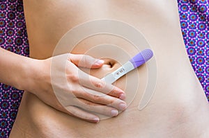Positive pregnancy test on belly