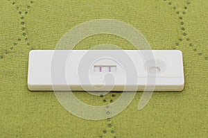 Positive pregnancy test on the green background