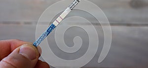 A positive pregnancy test in the male hand