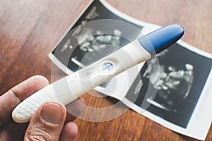 Positive pregnancy test in womans hand