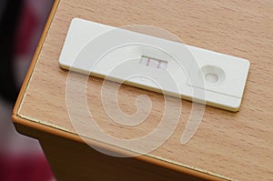 Positive pregnancy test on the wooden table
