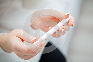 Positive pregnancy test. Young woman feeling depressed and sad a