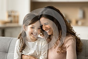 Positive pretty mom and adorable daughter kid talking