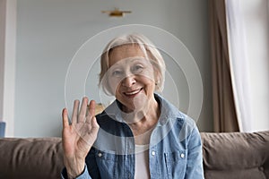 Positive pretty senior retired woman smiling at camera