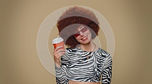 Positive pretty woman drinking coffee from cup, enjoying hot beverage in papercup, holding espresso