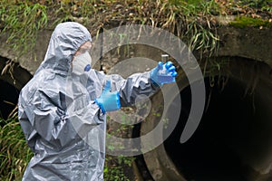 A positive reaction of the test results, a man in protective clothing, shows a good hand in a blue glove, against the background