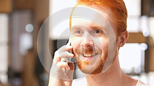 Positive Red Hair Beard Man talking on smart phone
