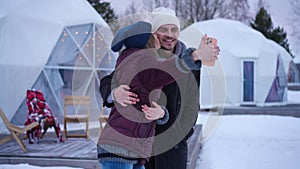 Positive relaxed young couple taking selfie standing on winter day outdoors. Caucasian loving boyfriend and girlfriend