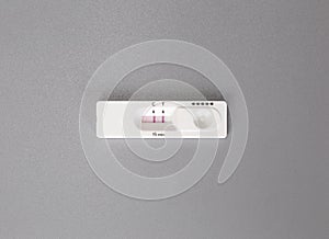 Positive result of coronavirus, covid-19 quick self test at home on gray background top view. Coronavirus,Health