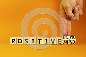 Positive results and mind symbol. Concept words Positive results or Positive mind on wooden cubes. Businessman hand. Beautiful