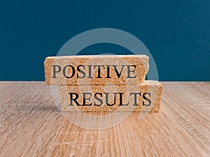 Positive results symbol. Concept words Positive results on brick blocks.