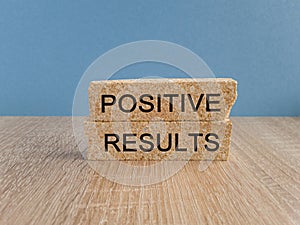 Positive results symbol. Concept words Positive results on brick blocks.