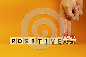 Positive results thought symbol. Concept words Positive results or Positive thoughts on cubes. Businessman hand. Beautiful orange