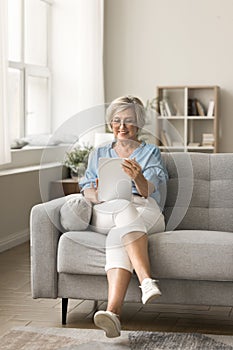 Positive satisfied senior retired customer woman using online medical service
