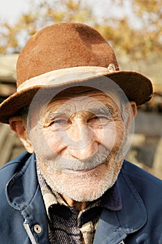 Positive senior man in hat photo