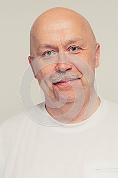 Positive senior man portrait with mustache bald