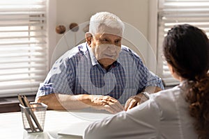 Positive senior 80s patient consulting doctor at appointment
