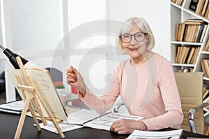 Positive senior woman studying subject