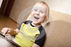 Positive small boy with tablet computer