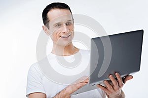 Positive smart man looking at the laptop screen