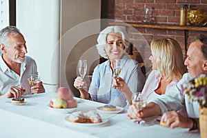 Positive smiling family sitting at the table