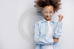 Positive smiling mulatto girl isolated over white background