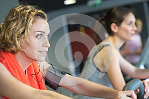 Positive smiling working out in modern fitness club