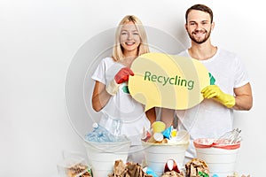 Positive smiling young man and woman advising people to recycle waste, rubbish