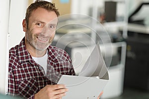 positive successful entrepreneur holding documents in folder photo