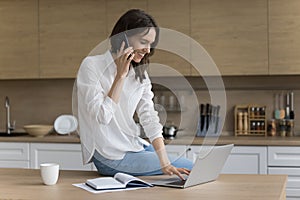 Positive successful freelancer woman speaking on cellphone